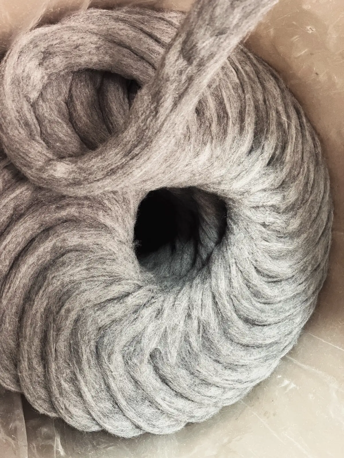 Close-up of grey sliver-knitted pile fabric