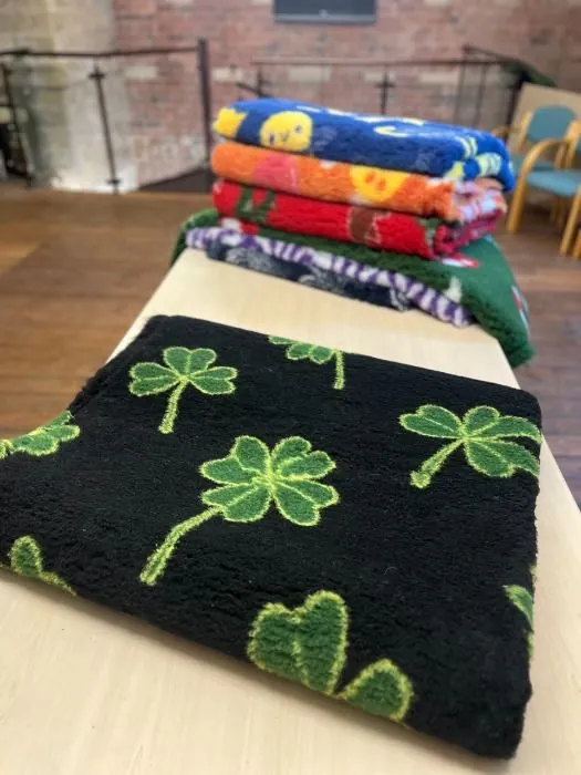 Stack of finished vet bedding rolls in colours and patterns