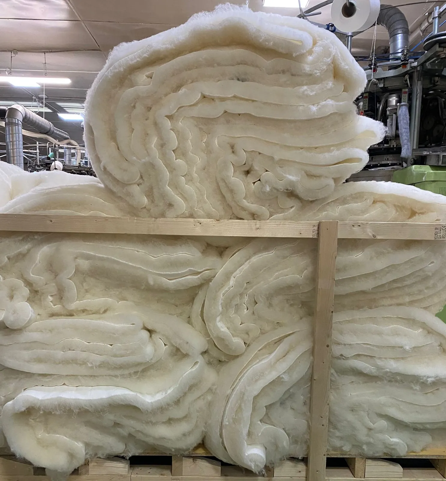 Undyed wool pile fabric stacked at the mill
