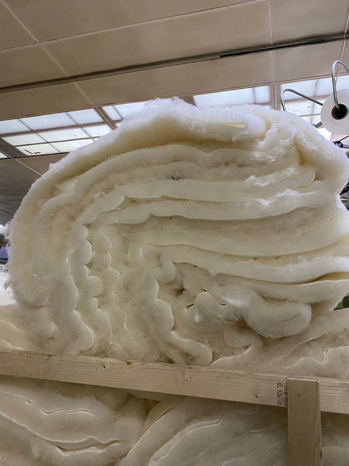 Undyed British wool pile fabric stacked at the mill