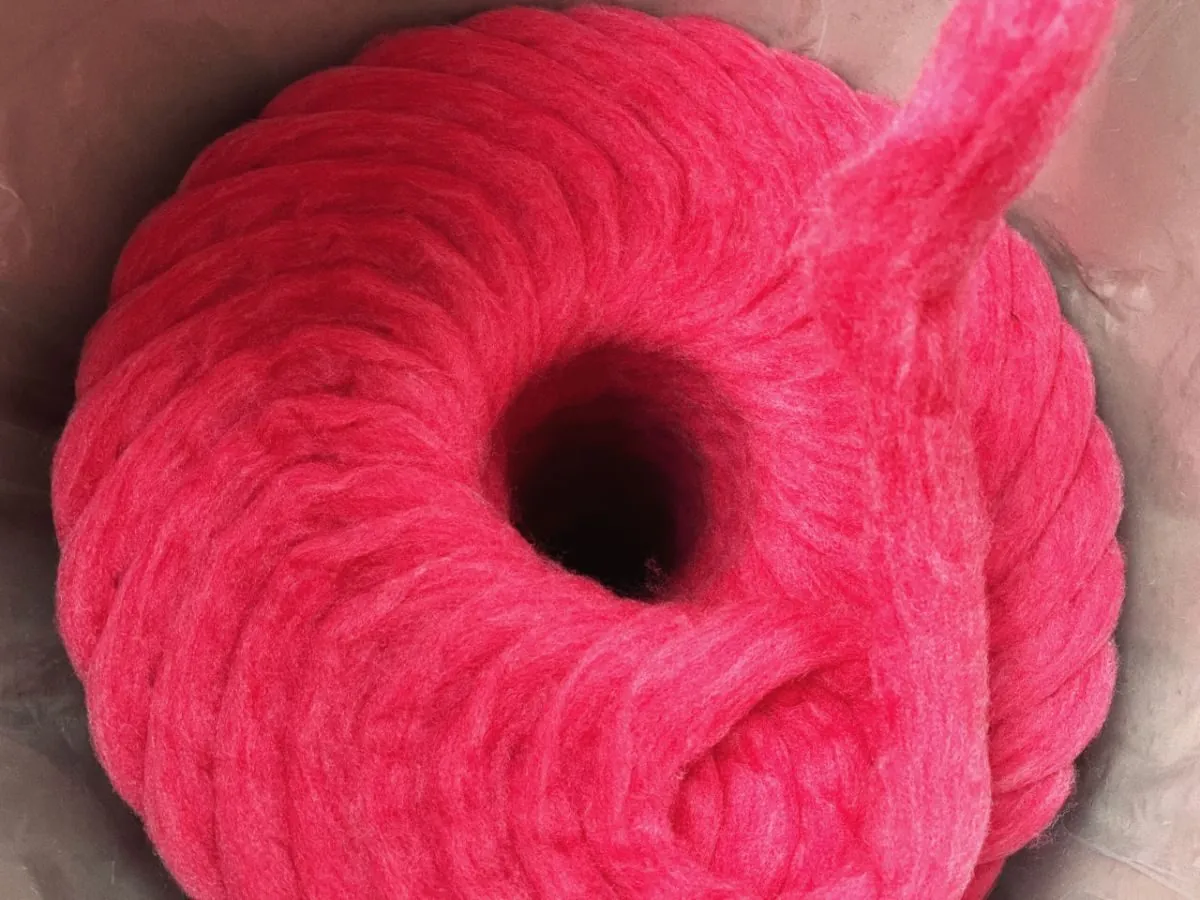 Coil of dope-dyed pink fibre