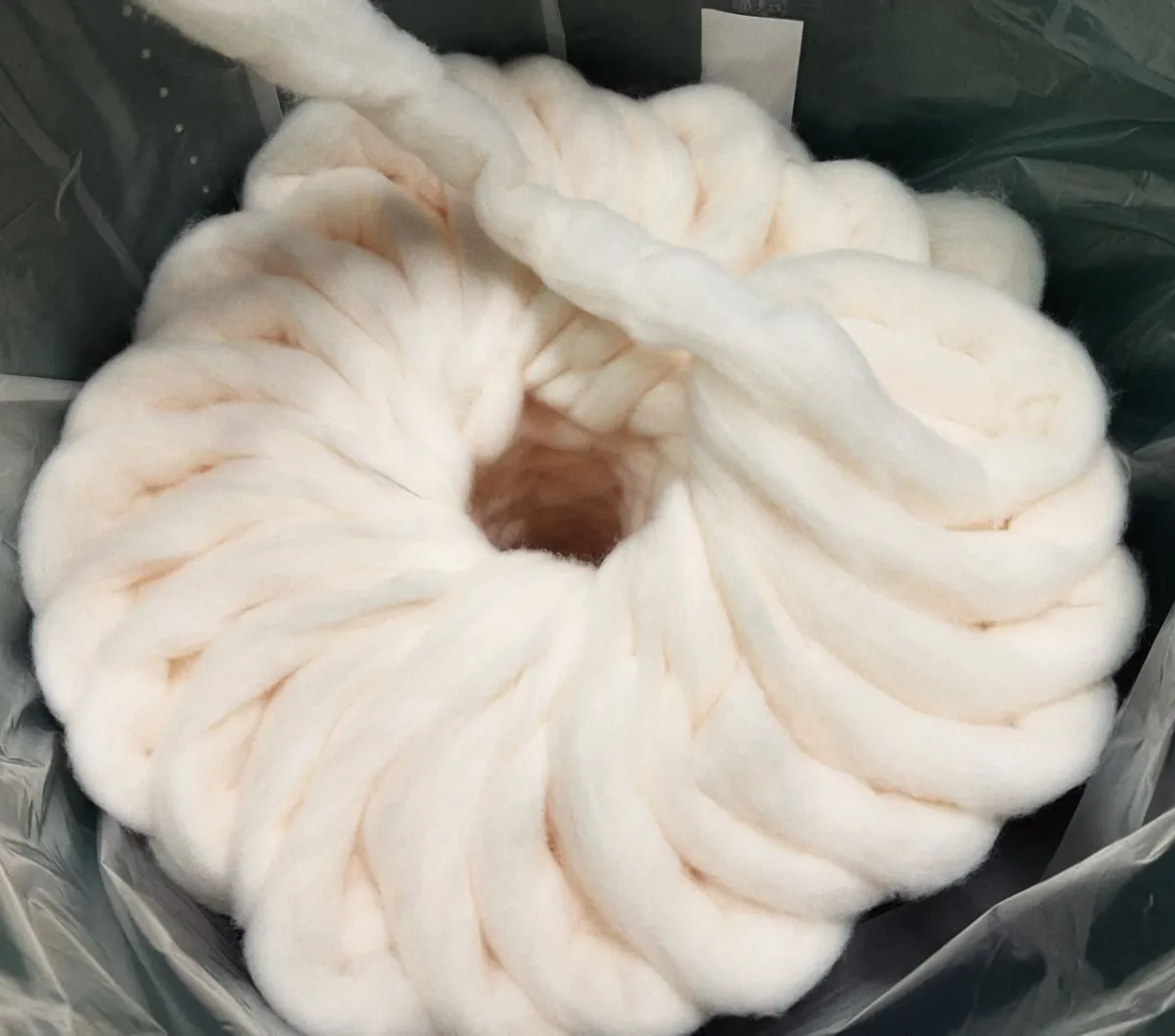 Coil of undyed fibre ready for the knitting machines